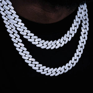 Triple multi‑layer stacked 16MM Rect Baguette Cuban Link Chain worn on dark‑skin black man neck, iced‑out mixed rectangular baguette cut and round flawless VVS simulated diamonds men’s miami cuban necklace, white gold plated heavy hip‑hop bling rapper jewelry, full layered sparkle display shot against deep solid black studio background, RDRIP JEWELRY
