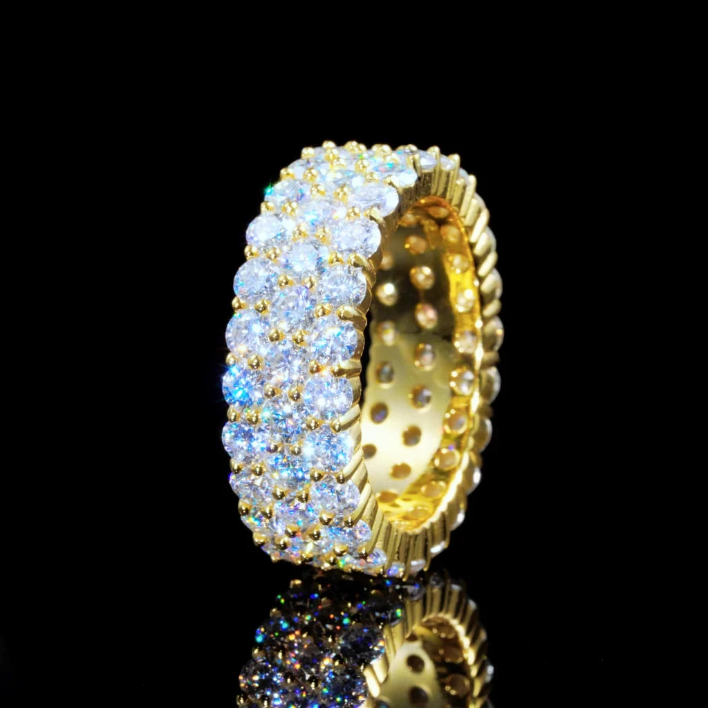18K gold plated genuine 925 sterling silver 3 row cluster eternity ring shot against black reflective background, densely hand set D‑color VVS1 plus 4mm round hearts and arrows moissanite stones, 8mm wide iced out hip hop unisex band ring, brilliant icy sparkle, GRA certified moissanite jewelry for men and women RDRIP JEWELRY