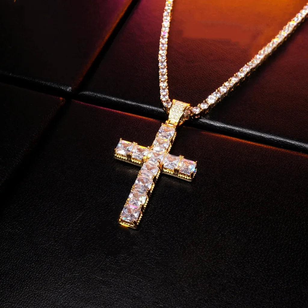 18k gold plated baguette cut cross pendant angled product shot, iced out vvs simulated diamond cross necklace paired with tennis chain, bling hip hop streetwear jewelry for men on black leather background RDRIP JEWELRY
