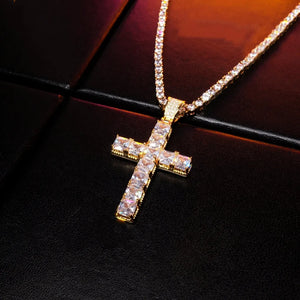 18k gold plated baguette cut cross pendant angled product shot, iced out vvs simulated diamond cross necklace paired with tennis chain, bling hip hop streetwear jewelry for men on black leather background RDRIP JEWELRY
