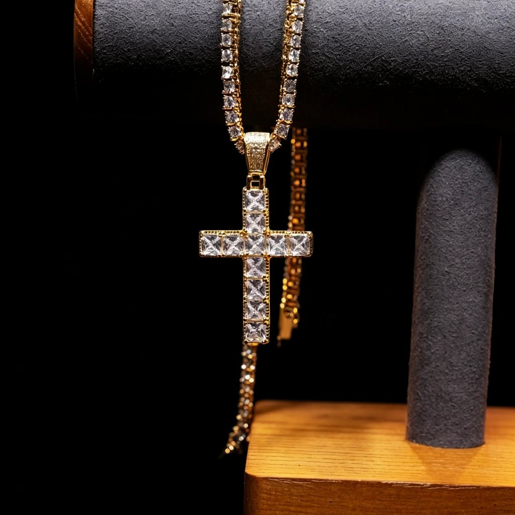 18k gold plated baguette cut iced out cross pendant hanging on jewelry display stand, vvs simulated diamond hip hop tennis chain necklace, bling streetwear men fashion jewelry against solid black background RDRIP JEWELRY

