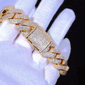 Extreme close-up micro shot of 19mm Full Iced Out Prong Cuban Link Bracelet in shiny 18K gold plating, displayed on soft white jewelry handling gloves against solid black background. Every cuban link and wide rectangular box clasp fully packed with lab-tested flawless VVS simulated diamonds, crafted with brand-new upgraded prong setting technology, solid copper core handcrafted to deliver bright icy reflective shine. Heavy oversized hip hop bling statement wrist jewelry for men and women, scratch & tarnish 