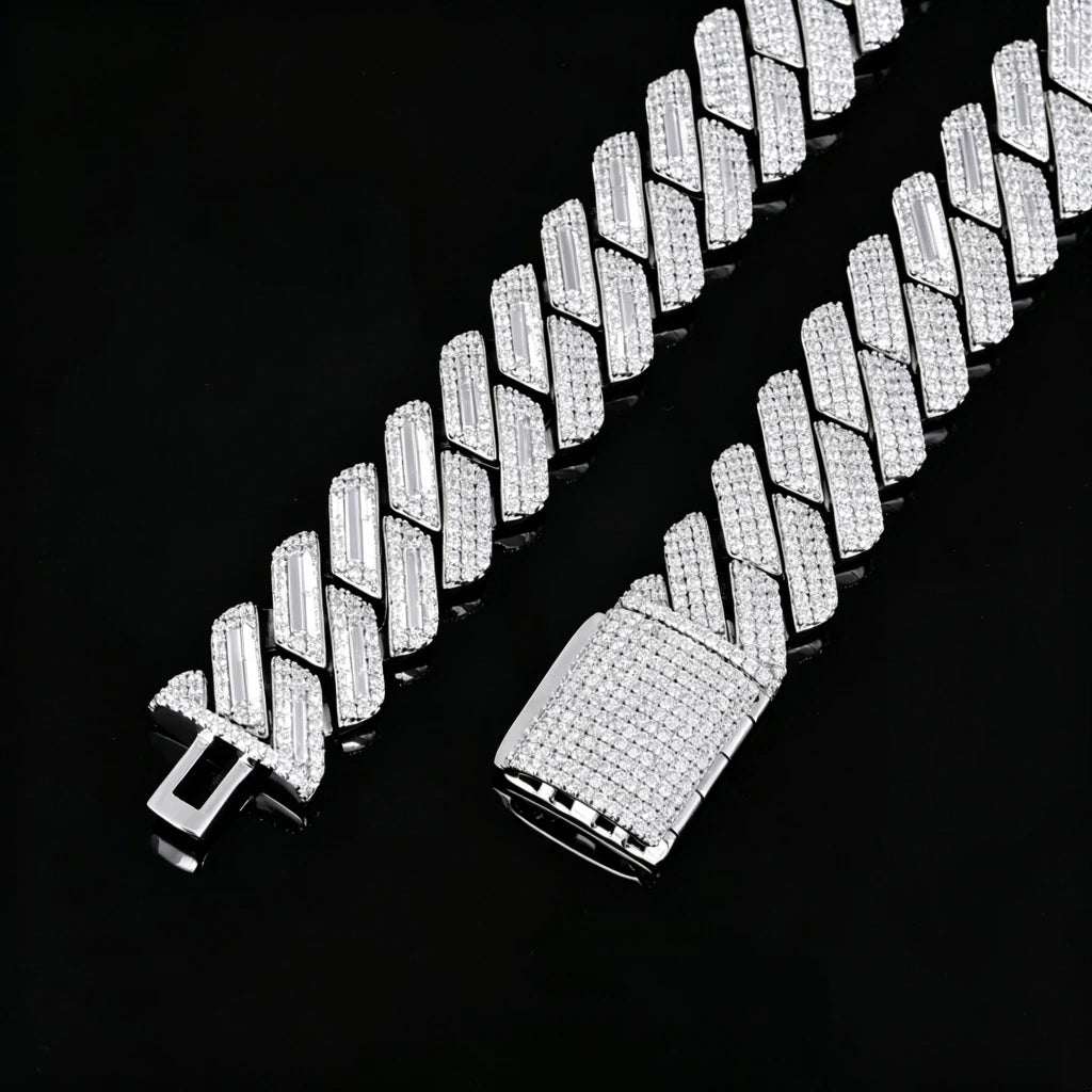 Flat lay studio product shot of 19mm full iced out prong set rectangular baguette cuban link chain for men, polished 18K white gold plated solid copper base, two chain ends displayed side by side showing empty insertion clasp and fully micro pave diamond covered box clasp, every link hand-set with flawless VVS grade simulated diamond stones, laid flat on glossy black reflective mirror board with natural soft mirror reflection, heavy thick hip hop street bling statement jewelry close-up detail photo RDRIP