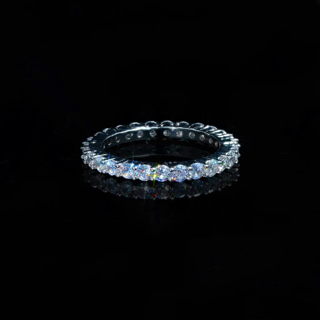 2mm ripple micro pave iced stacking band ring, studio product shot of cubic zirconia thin band ring, bright stone sparkle with light flare, displayed on reflective black surface, hip hop icy fine jewelry RDRIP JEWELRY
