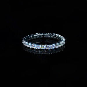 2mm ripple micro pave iced stacking band ring, studio product shot of cubic zirconia thin band ring, bright stone sparkle with light flare, displayed on reflective black surface, hip hop icy fine jewelry RDRIP JEWELRY

