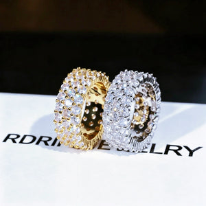 3‑Row Fully Paved Iced Out Eternity Ring gold and white gold plated pair displayed on RDRIP JEWELRY branded card, 8mm width full wrap hip hop eternity band ring, hand‑set 4MM flawless VVS CZ simulated diamonds, heavy bling icy pave hip‑hop jewelry for men women, sparkling simulated diamond full eternity ring close‑up shot RDRIP JEWELRY SINCE 2016
