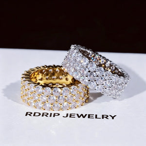 3‑Row Fully Paved Iced Out Eternity Ring stacked display of gold plated and white gold plated hip hop eternity bands on RDRIP JEWELRY branded card, 8mm width full wrap band, hand‑set 4MM flawless VVS CZ simulated diamonds, heavy micro pave icy bling hip‑hop jewelry for men women, sparkling full paved simulated diamond rings stacked angle shot RDRIP JEWELRY SINCE 2016