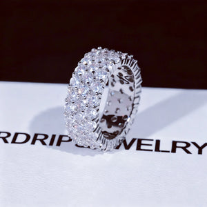 3‑Row Fully Paved Iced Out Eternity Ring single white gold plated close‑up shot on RDRIP JEWELRY branded card, 8mm width full wrap hip hop eternity band ring, hand‑set 4MM flawless VVS CZ simulated diamonds, heavy micro pave bling icy hip‑hop statement ring for men women, sparkling full paved simulated diamond ring detail view RDRIP JEWELRY SINCE 2016
