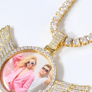 Extreme close-up detail shot of gold 3D Angle Wing Custom Picture Pendant, fully iced diamond bezel, encrusted bail and matching tennis chain with custom couple photo inside, RDRIP Jewelry
