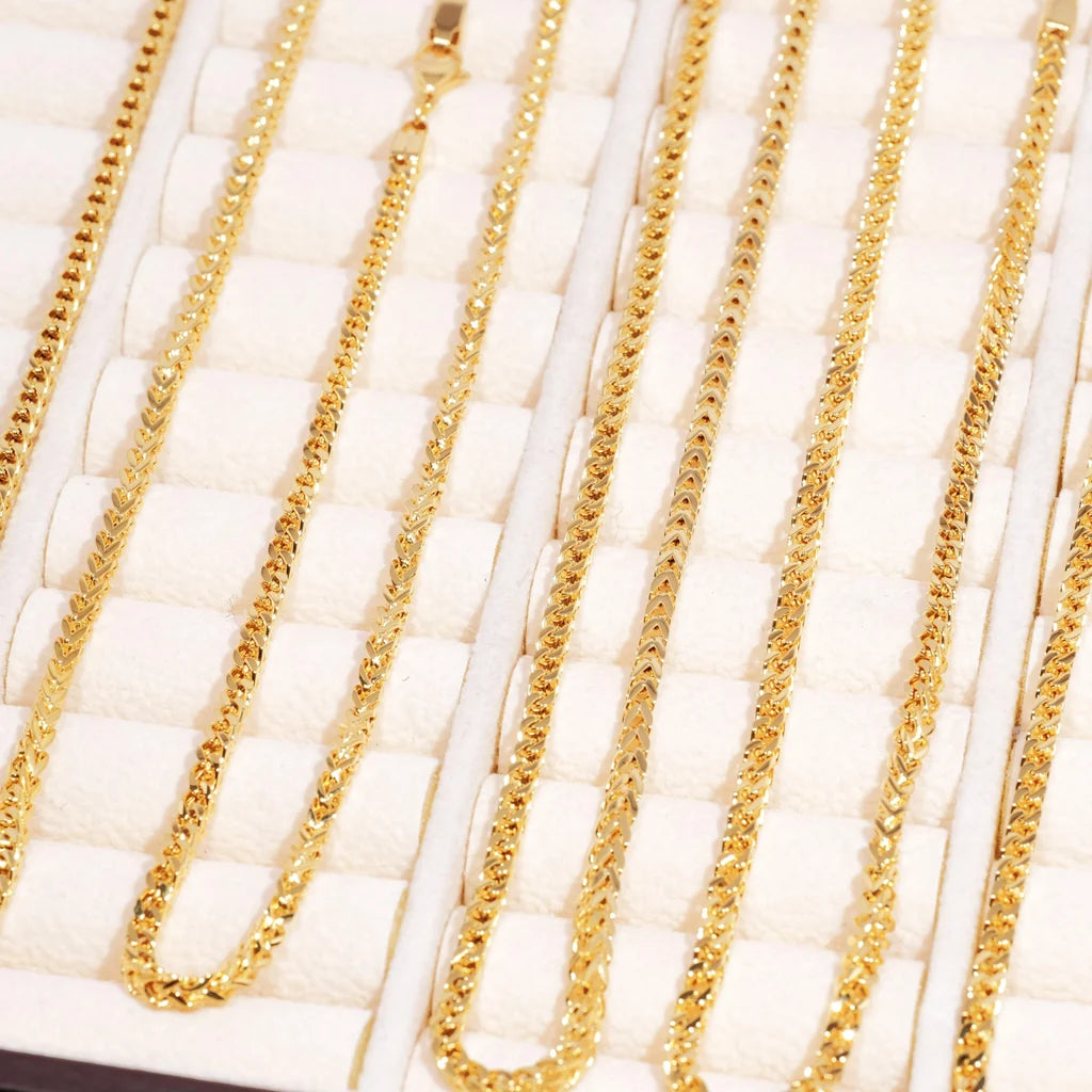 3mm 18k Gold Plated Italian Franco Link Chain bulk display shot, multiple different length shiny gold Franco necklaces neatly arranged inside soft white compartment jewelry tray, polished tangle resistant flexible Franco chain links, unisex hip hop stacking gold chain available in 18 20 24 inch sizes, durable tarnish free gold bling necklace compatible with custom pendants, close up flat lay product showcase of classic streetwear Franco link jewelry for men women, premium hand polished everyday statement 