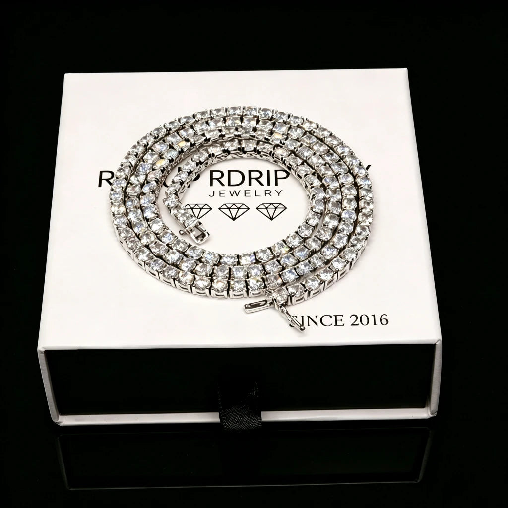 3MM iced‑out single‑row tennis‑chain necklace coiled neatly on branded white gift box, prong‑set VVS grade CZ simulated diamonds, brilliant bling shine, unisex hip‑hop fashion jewelry for men women, premium gift‑ready packaging, RDRIP JEWELRY
