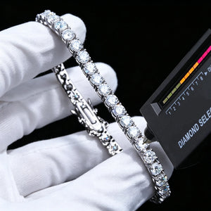 Professional studio test photo of 4mm round D color VVS1 clarity moissanite tennis bracelet with thick 18K white gold plating on solid S925 sterling silver base, each flawless moissanite gem hand prong-set with brilliant rainbow fire sparkle, held by clean soft white cotton jewelry gloves on solid pure black background, handheld diamond selector tester touching stone to verify diamond passing performance, full visible double safety clasp structure, unisex icy hip hop iced out luxury wrist chain for men and 