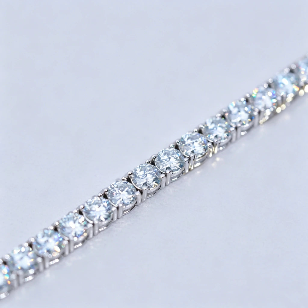 Ultra detailed macro close-up shot showcasing row of 4mm ideal Hearts & Arrows cut D Color VVS1+ clarity moissanite stones on unisex tennis bracelet, solid genuine S925 sterling silver base wrapped in thick premium 18K white gold plating, each colorless flawless moissanite gem individually hand prong-set by professional jewelry artisans, intense rainbow fire light refraction and bright icy sparkle on every round stone, bracelet laid flat on smooth clean plain white background with all golden text logos and 