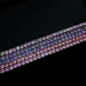 4mm Aurora Rainbow Iced Tennis Chain side angle view, close‑up of pastel pink purple blue ombré gradient VVS CZ simulated diamonds, hand prong‑set stones, 18K gold plated unisex hip hop bling necklace on black studio background, RDRIP JEWELRY
