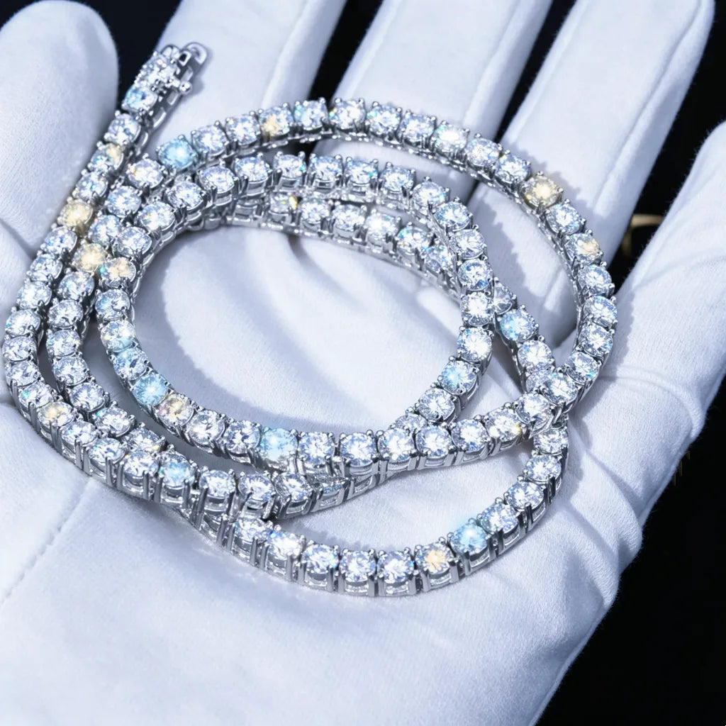 4MM VVS1 D‑Color Moissanite Tennis Chain coiled and stacked, held in clean white jewelry inspection gloves, 925 Sterling Silver White Gold Plated, ideal hearts and arrows cut moissanite stones with brilliant fire and sparkle, dark studio background, premium iced‑out hip hop necklace close‑up shot RDRIP JEWELRY
