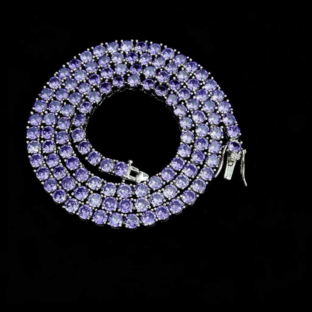 4mm Aurora Rainbow Iced Tennis Chain coiled overhead view, deep purple pastel ombré gradient round VVS CZ simulated diamonds, hand prong‑set stones, sturdy metal lock clasp detail, brilliant sparkling starburst shine, 18K gold plated unisex hip hop bling necklace on solid black studio background, RDRIP JEWELRY

