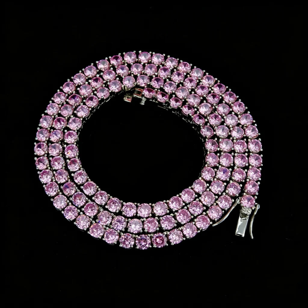 4mm Aurora Rainbow Iced Tennis Chain coiled top angle view, pastel pink purple blue ombre gradient VVS simulated CZ diamonds, hand prong‑set round stones, visible metal lock clasp, brilliant starburst shine, 18K gold plated unisex hip hop bling necklace on solid black background, RDRIP JEWELRY
