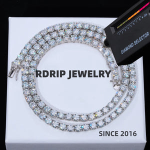 5MM round brilliant VVS1 D color moissanite tennis chain necklace made of solid S925 sterling silver with white gold plating, lab moissanite stone passes professional diamond selector tester, ultra sparkly icy hand-set moissanite stones with strong star fire shine, anti-tarnish unisex hip hop iced out tennis chain jewelry, laid flat on clean plain white luxury gift box background, no distracting text, brilliant stone luster and bright chain finish preserved, premium streetwear bling accessory for men women 