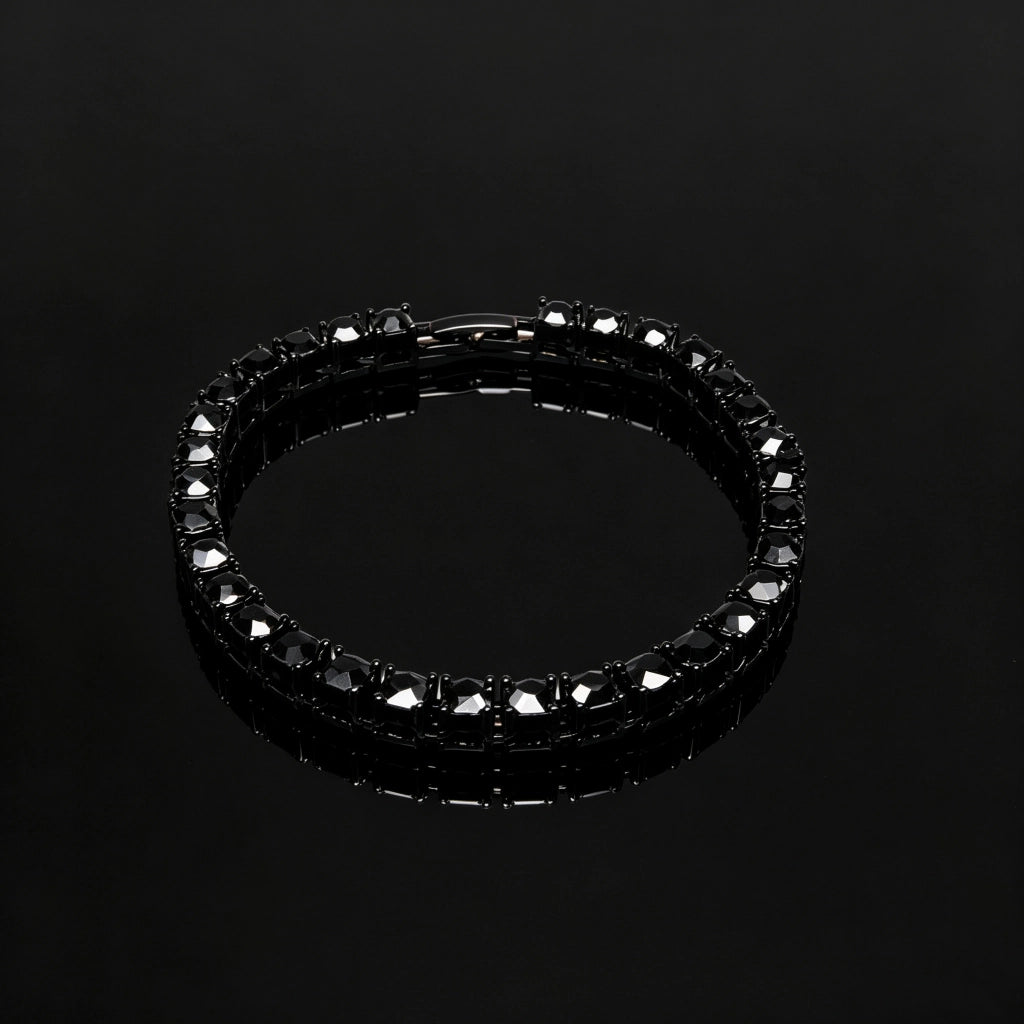 Slight angle view of 5mm Black Iced Out Tennis Bracelet, hand‑set flawless VVS black simulated diamonds, alloy material with vacuum black plating, single row hip hop bling tennis bracelet with secure box clasp, unisex dark streetwear wrist jewelry for men and women, product photograph on pure black glossy reflective surface, RDRIP JEWELRY
