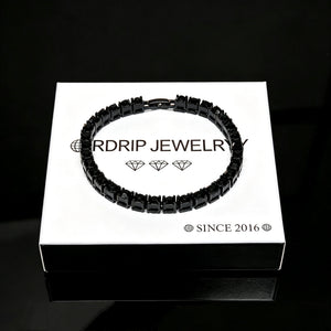 5mm Black Iced Out Tennis Bracelet resting on RDRIP JEWELRY branded gift box, prong‑set flawless VVS black simulated diamonds alloy vacuum plating hip hop unisex bling bracelet product shot on pure black reflective surface, luxury men women streetwear jewelry, RDRIP JEWELRY
