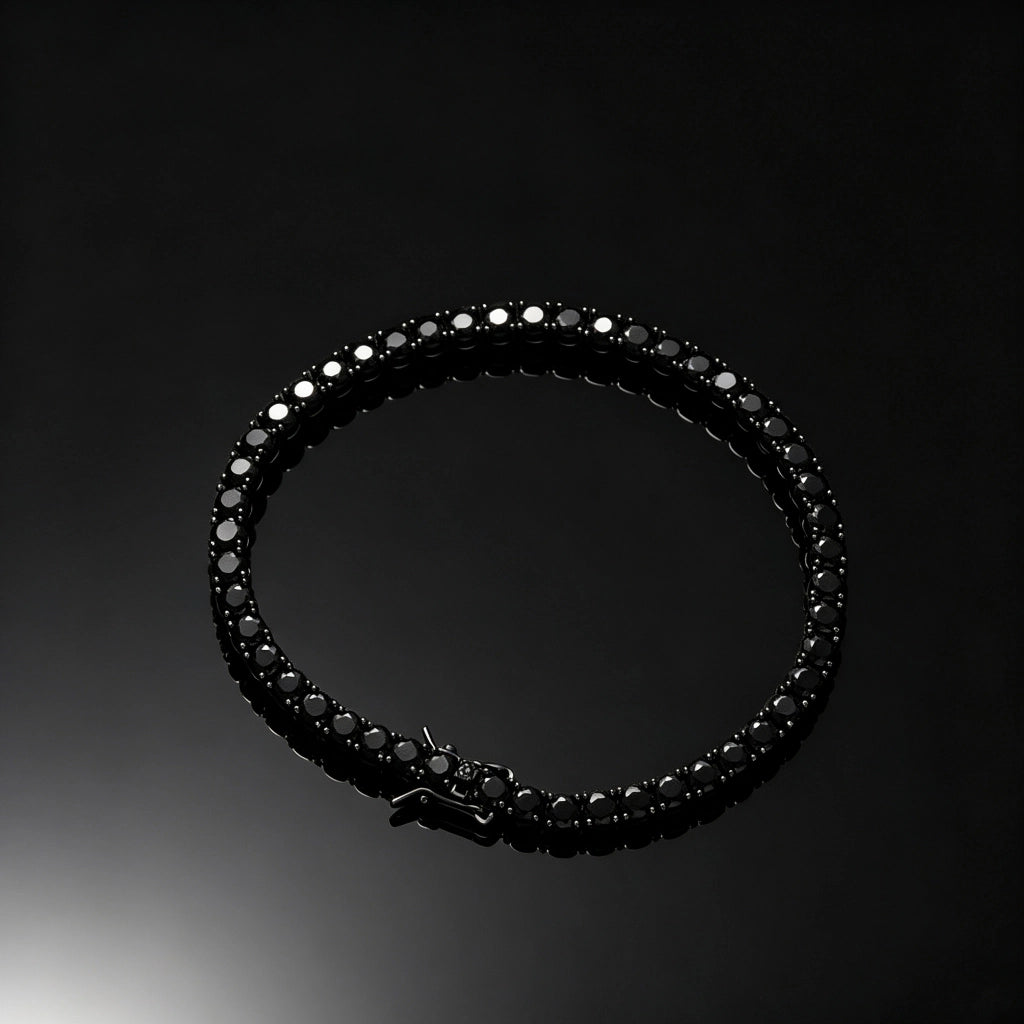 Top‑down flat lay shot of 5mm Black Iced Out Tennis Bracelet, prong‑set flawless VVS black simulated diamonds, alloy with vacuum black plating unisex hip hop bling bracelet, secure box clasp design, displayed on pure black glossy reflective surface, dark streetwear wrist jewelry for men women, RDRIP JEWELRY
