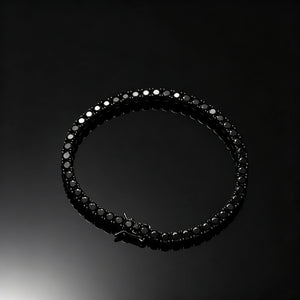 Top‑down flat lay shot of 5mm Black Iced Out Tennis Bracelet, prong‑set flawless VVS black simulated diamonds, alloy with vacuum black plating unisex hip hop bling bracelet, secure box clasp design, displayed on pure black glossy reflective surface, dark streetwear wrist jewelry for men women, RDRIP JEWELRY
