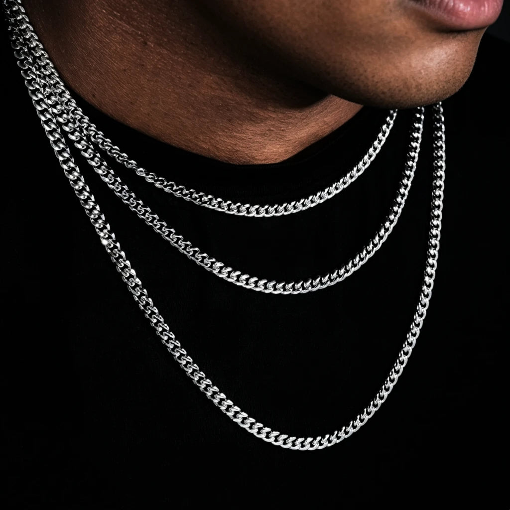 Closeup layered shot of men wearing 5mm stackable 18k white gold Miami Cuban link chain set, polished tangle-free flexible cuban necklace for hip hop street style, multi-length layering design for men urban jewelry, smooth hand-finished bold uniform links premium white gold plated bling, perfect solo wear or match custom pendants, timeless stackable mens statement chain for casual streetwear, handcrafted tarnish resistant hip hop jewelry with lifetime warranty RDRIP JEWELRY

