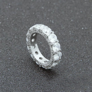 close‑up view of silver plated 5mm iced out round full eternity ring bold prong set aaa cubic zirconia full band ring side micro pave icy details hip hop unisex statement ring dark speckled textured background RDRIP JEWELRY

