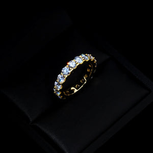6.00 CARAT S925 VVS1+ moissanite single‑row full eternity ring, 4mm round ideal cut hearts and arrows moissanite stones, 18K gold plated genuine 925 sterling silver band, golden icy sparkling full circle band ring placed inside luxury black satin jewelry gift box, dark moody studio close‑up shot, brilliant light sparkle, unisex hip‑hop wedding engagement stackable fine bling jewelry RDRIP JEWELRY