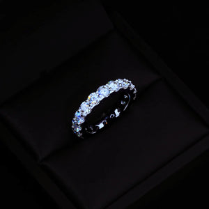 6.00 CARAT S925 VVS1+ moissanite single‑row full eternity ring 4mm round ideal cut hearts and arrows stones resting inside black luxury gift box setting, brilliant sparkling icy full band ring genuine 925 sterling silver white gold plated, premium hip‑hop wedding stackable band ring dark elegant product shot men women fine bling jewelry RDRIP JEWELRY