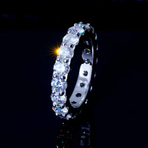 6.00 CARAT S925 VVS1+ moissanite single‑row full eternity ring 4mm round ideal cut hearts and arrows stones, white gold plated genuine 925 sterling silver band, brilliant moissanite stones with sparkle star light flare effect, close‑up side view shot, icy full circle band ring for hip‑hop wedding stacking, unisex luxury bling fine jewelry dark background product photography RDRIP JEWELRY