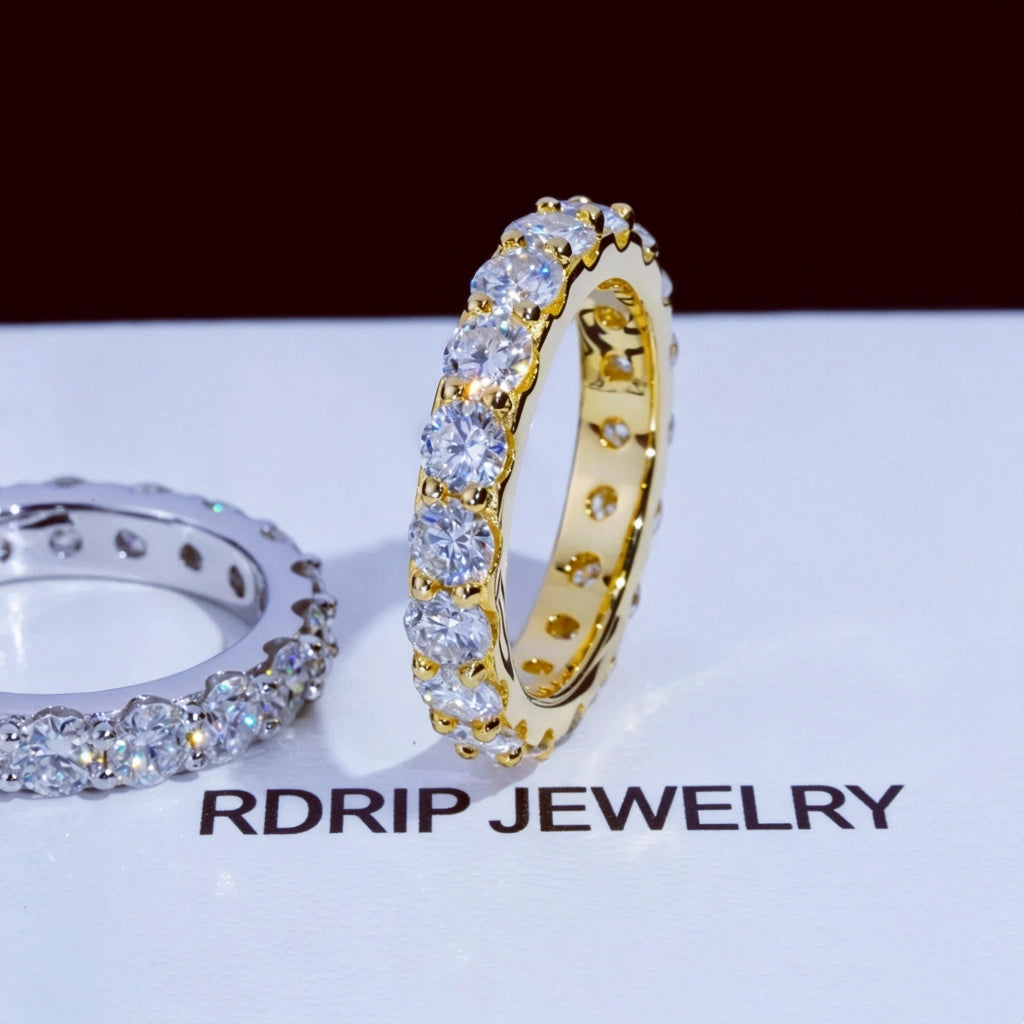 6.00 CARAT S925 VVS1+ moissanite single‑row full eternity ring 4mm round ideal cut hearts and arrows moissanite stones, side‑by‑side comparison of 18K gold plated and white gold plated 925 sterling silver band, two tone unisex icy stackable hip‑hop wedding ring displayed on printed RDRIP JEWELRY branded surface, brilliant sparkling full circle band fine bling jewelry product shot RDRIP JEWELRY