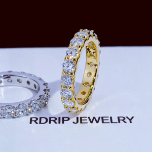 6.00 CARAT S925 VVS1+ moissanite single‑row full eternity ring 4mm round ideal cut hearts and arrows moissanite stones, side‑by‑side comparison of 18K gold plated and white gold plated 925 sterling silver band, two tone unisex icy stackable hip‑hop wedding ring displayed on printed RDRIP JEWELRY branded surface, brilliant sparkling full circle band fine bling jewelry product shot RDRIP JEWELRY