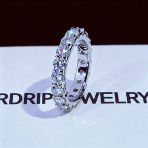 6.00 CARAT S925 VVS1+ moissanite single‑row full eternity ring, 4mm round ideal cut hearts and arrows moissanite stones, white gold plated genuine 925 sterling silver band, icy brilliant sparkling full circle band ring, single ring side view close‑up shot, displayed on RDRIP JEWELRY branded printed white surface, unisex hip‑hop wedding stackable fine bling jewelry dark background product photography RDRIP JEWELRY