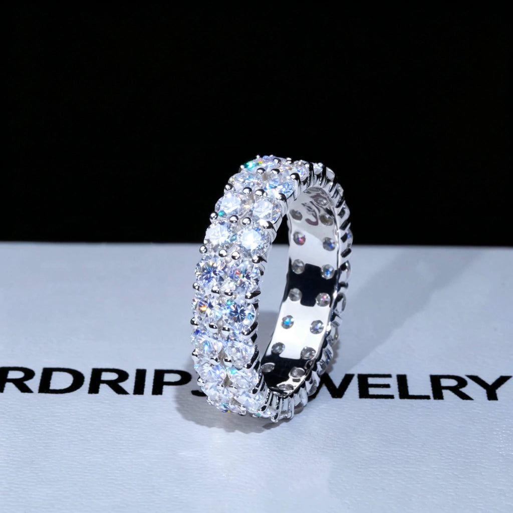 6 mm width double‑row full pave moissanite eternity ring displayed on branded RDRIP JEWELRY gift box, hand‑set D‑Color VVS1+ 4 mm round hearts‑and‑arrows moissanite stones, genuine 925 sterling silver white‑gold‑plated icy hip‑hop unisex ring, brilliant multi‑angle sparkle, premium bling statement jewelry for men and women RDRIP JEWELRY SINCE 2016

