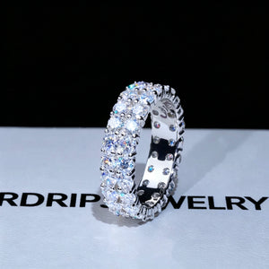 6 mm width double‑row full pave moissanite eternity ring displayed on branded RDRIP JEWELRY gift box, hand‑set D‑Color VVS1+ 4 mm round hearts‑and‑arrows moissanite stones, genuine 925 sterling silver white‑gold‑plated icy hip‑hop unisex ring, brilliant multi‑angle sparkle, premium bling statement jewelry for men and women RDRIP JEWELRY SINCE 2016
