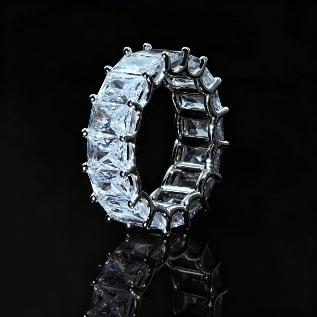 7mm baguette eternity ring 925 silver white gold plated iced out hip hop band, side profile view of full around baguette cut cubic zirconia mens ring, silver tone prong setting bling hiphop jewelry, black reflective studio background RDRIP JEWELRY
