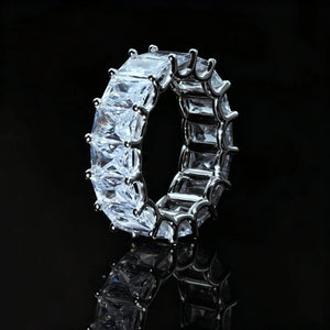 7mm baguette eternity ring 925 silver white gold plated iced out hip hop band, side profile view of full around baguette cut cubic zirconia mens ring, silver tone prong setting bling hiphop jewelry, black reflective studio background RDRIP JEWELRY

