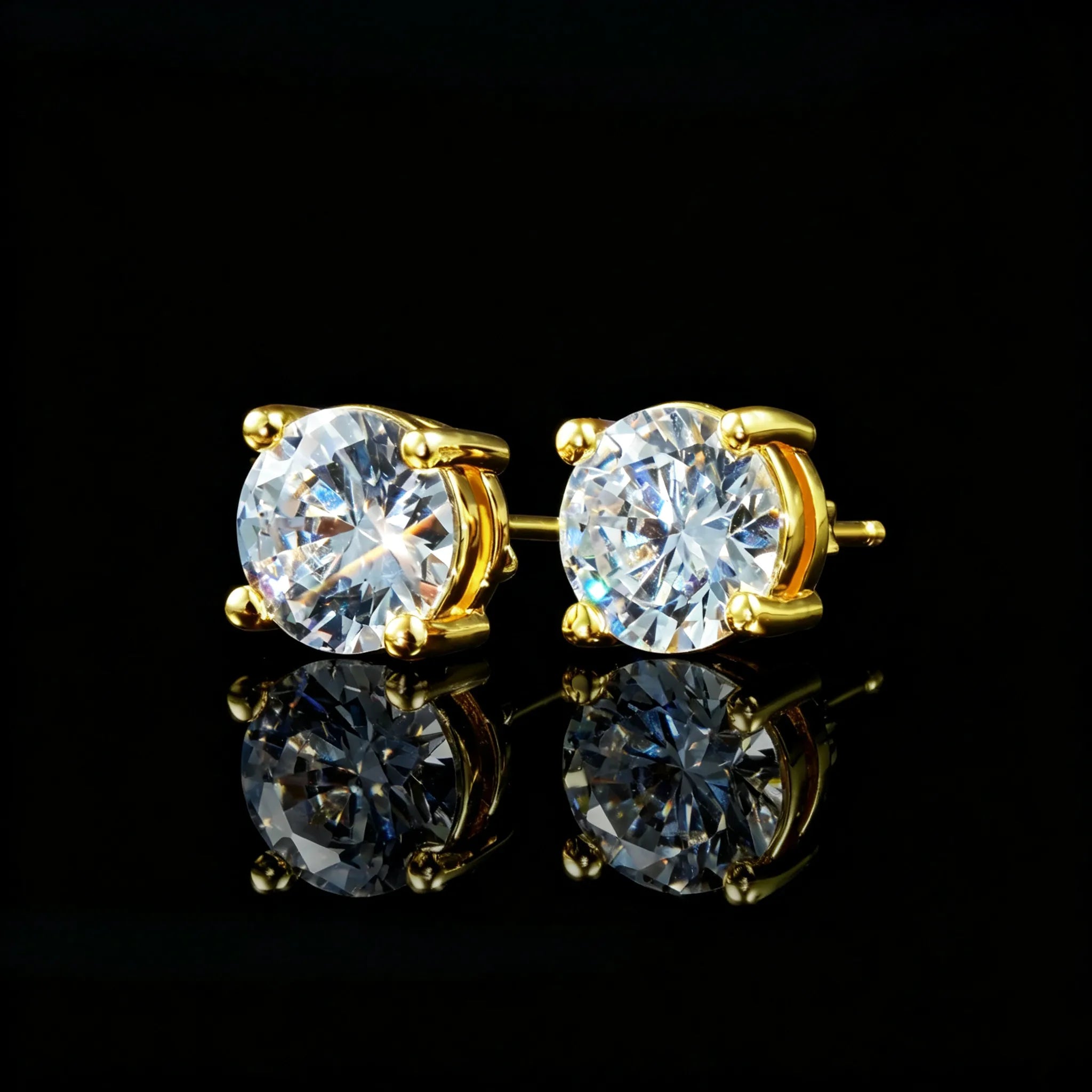 Close-up shot of 8mm Iced Brilliant Cut 4-Prong Gold Stud Earrings, shiny round moissanite solitaire studs with reflection, black background hip hop jewelry RDRIP JEWELRY
