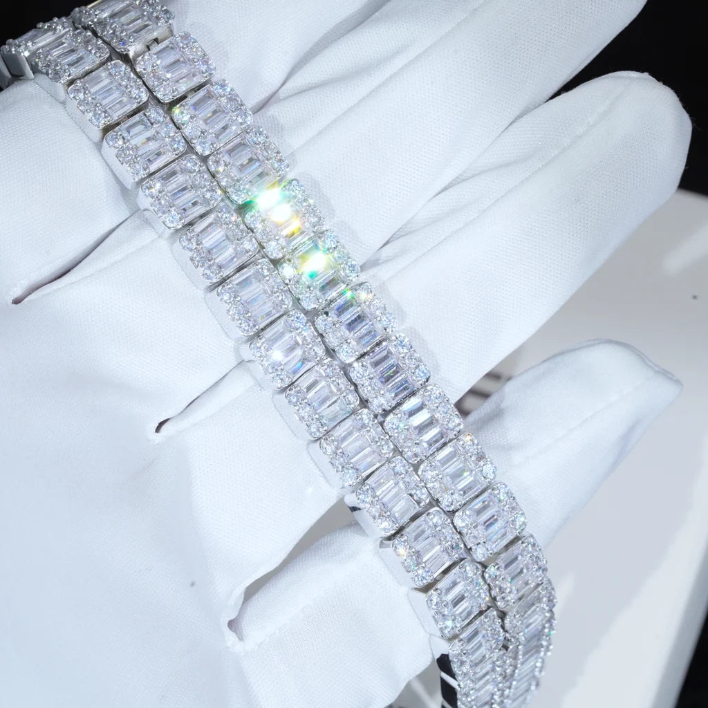 Angled shot of 8mm  width iced baguette cluster tennis bracelet resting on white cotton glove, flawless VVS simulated baguette cluster diamonds with bright rainbow‑colored light reflection and sparkling starburst glints, white gold plated copper hip hop bling wrist bracelet, unisex luxury iced‑out hip‑hop jewelry for men women RDRIP JEWELRY
