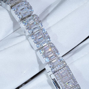 Close‑up macro shot of 8mm 9.5mm width iced baguette cluster tennis bracelet, hand‑set flawless VVS simulated baguette and round diamonds, white gold plated copper hip hop bling bracelet, intricate stone cluster details on white fabric background, premium iced out hip‑hop jewelry for men women RDRIP JEWELRY
