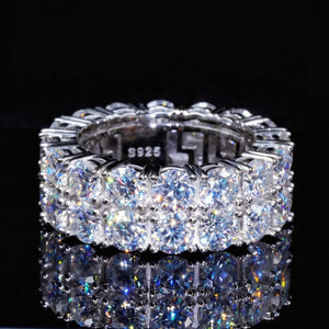 Black background product shot of 9mm double row round D-color VVS1 moissanite full eternity band ring for men, hand-set hearts and arrows ideal cut moissanite stones, genuine 925 sterling silver white gold plated icy hip-hop bling ring, sparkling high-refraction moissanite stones with bright starburst light and long fiery flashes, luxury mens hip-hop finger band displayed on dark reflective surface, premium statement jewelry from RDRIP JEWELRY
