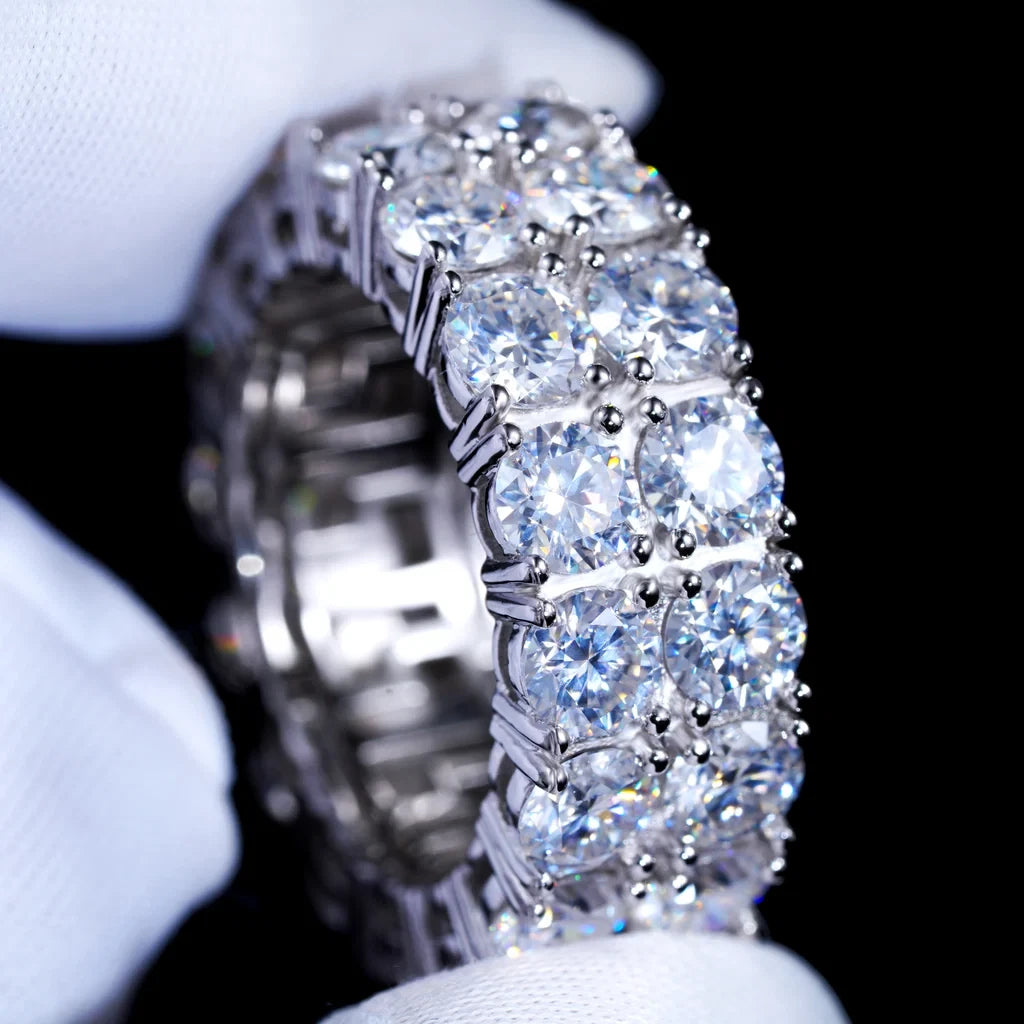 Close‑up shot of 9mm double row round D‑color VVS1 moissanite full eternity band ring for men, hand‑set hearts and arrows ideal cut moissanite stones, genuine 925 sterling silver white gold plated icy hip‑hop bling ring, sparkling high‑refraction moissanite jewelry held in white microfiber gloves, luxury mens hip‑hop finger band from RDRIP JEWELRY
