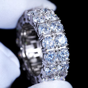 Close‑up shot of 9mm double row round D‑color VVS1 moissanite full eternity band ring for men, hand‑set hearts and arrows ideal cut moissanite stones, genuine 925 sterling silver white gold plated icy hip‑hop bling ring, sparkling high‑refraction moissanite jewelry held in white microfiber gloves, luxury mens hip‑hop finger band from RDRIP JEWELRY
