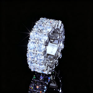 Three‑quarter angled view of 9mm double‑row round D‑color VVS1 moissanite full eternity band ring for men, hand‑set hearts and arrows ideal‑cut moissanite stones, genuine 925 sterling silver white gold plated icy hip‑hop bling ring, brilliant starburst sparkle and vivid color fire flashes, ring interior S925 stamp visible, displayed on glossy dark reflective surface against pure black background, luxury urban hip‑hop mens statement band jewelry from RDRIP JEWELRY
