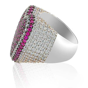 Three‑quarter angled studio shot of magenta pink iced out pave love heart ring, heavy thick wide band with polished smooth inner shank, densely hand‑set AAA cubic zirconia pink and clear stones, full micro pave hip hop bling heart ring, subtle soft reflection on clean white background, unisex statement rapper jewelry for men women RDRIP JEWELRY
