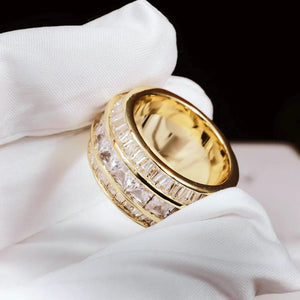 Close‑up detail shot of gold Baguette Square Triple Row Ring held with white microfiber glove, 12mm wide men hip hop band ring, hand set flawless VVS simulated baguette and square diamonds full pavé heavy weight 18k gold plated icy mens statement jewelry RDRIP JEWELRY
