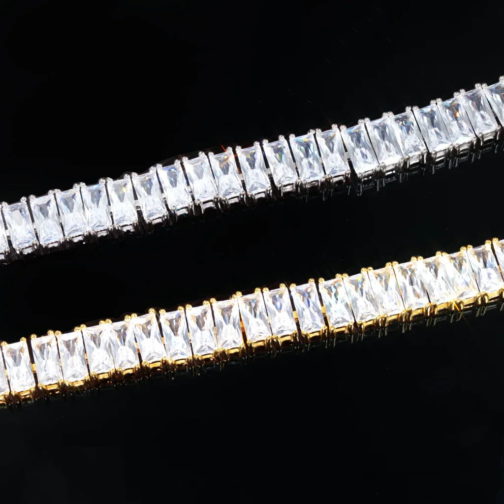 Blaze Retro Baguette‑Cut Iced Tennis Bracelet macro close‑up detail shot, side‑by‑side 18k gold plated and silver‑toned tennis bracelet, hand‑set rectangular baguette‑cut AAA cubic zirconia stones, prong setting hip hop bling jewelry, high clarity simulated diamond stones on black background showing stone brilliance and prong craftsmanship RDRIP JEWELRY
