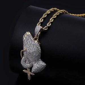 Back side view of iced two tone blessing praying hands pendant with dangling cross charm, fully paved flawless VVS simulated diamonds, copper 18k gold plated hip hop men faith bling jewelry displayed on black leather stand RDRIP JEWELRY
