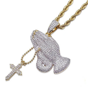 Diagonal angle shot of iced two tone blessing praying hands pendant with dangling cross charm attached to gold rope chain, fully paved flawless VVS simulated diamonds, copper 18k gold plated men faith hip hop bling jewelry isolated on white background RDRIP JEWELRY
